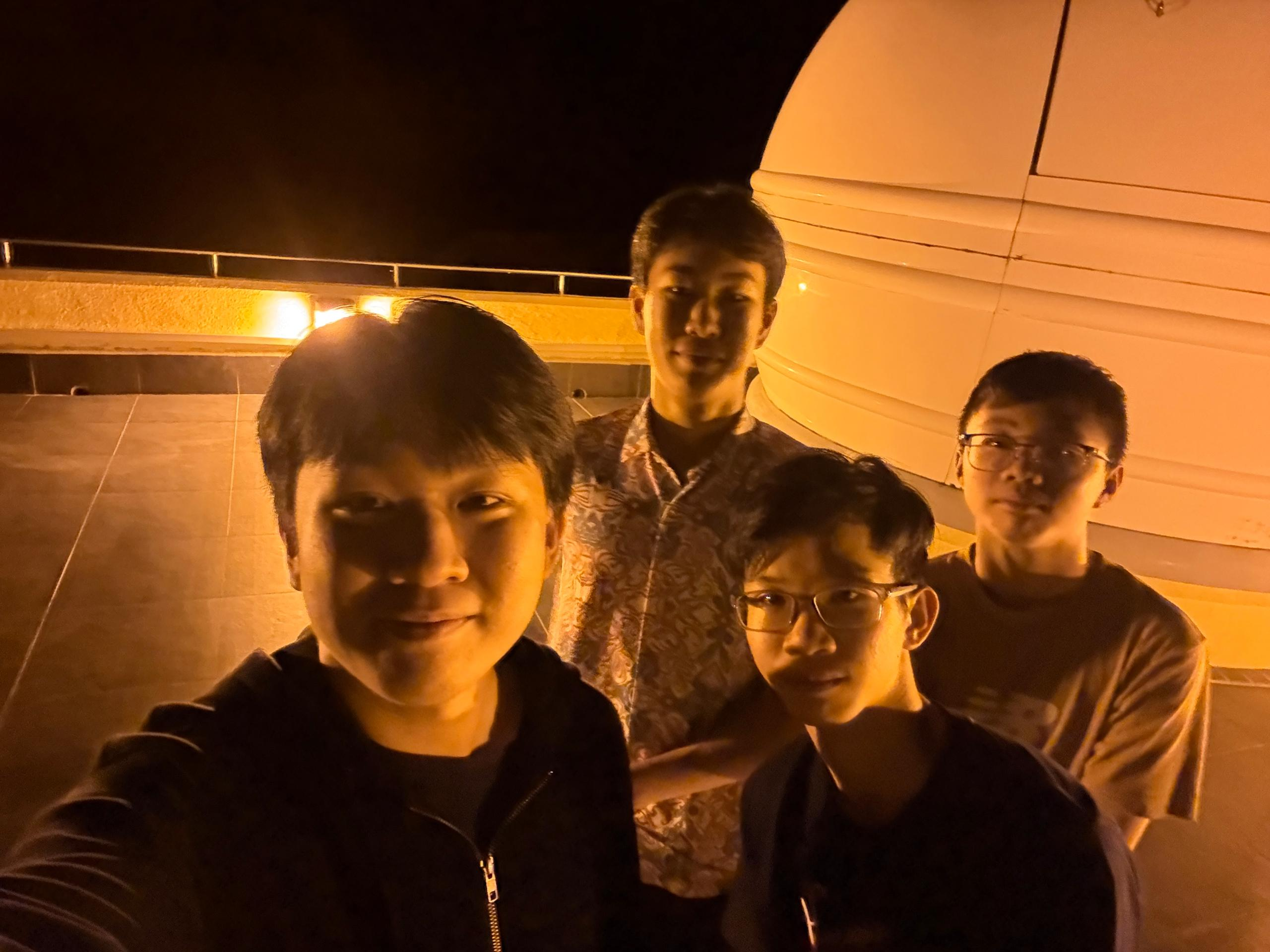 Olympiad students taking a night-time group selfie
