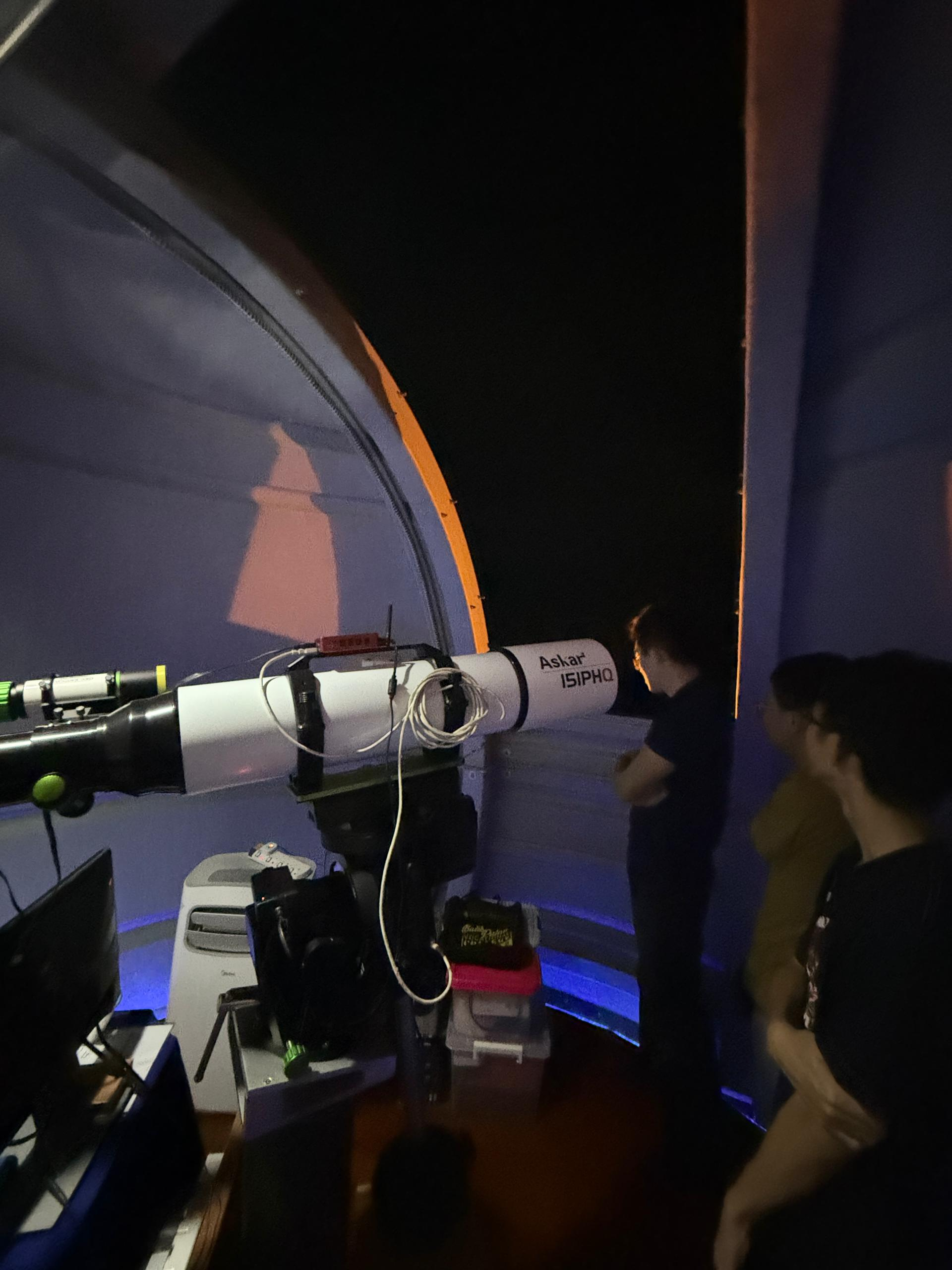 Students observing through a telescope at an observatory